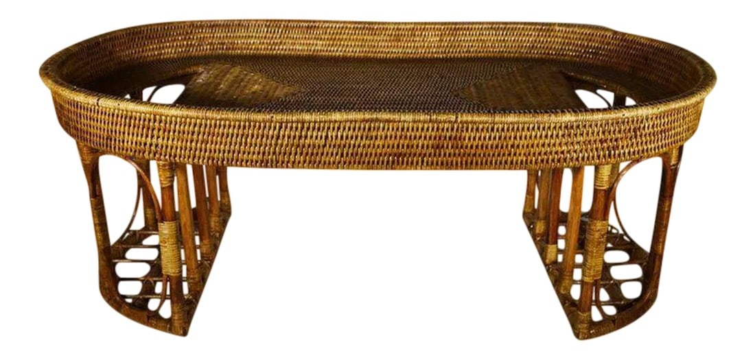Vintage Burmese Handwoven Rattan Breakfast Coffee Serving Table From the 1970s: A 20th century coffee serving table handwoven with rattan in Burma. This table adopts an oval shape resting on two half-moon legs. These legs are made with thick rattan rods organized as an openwork