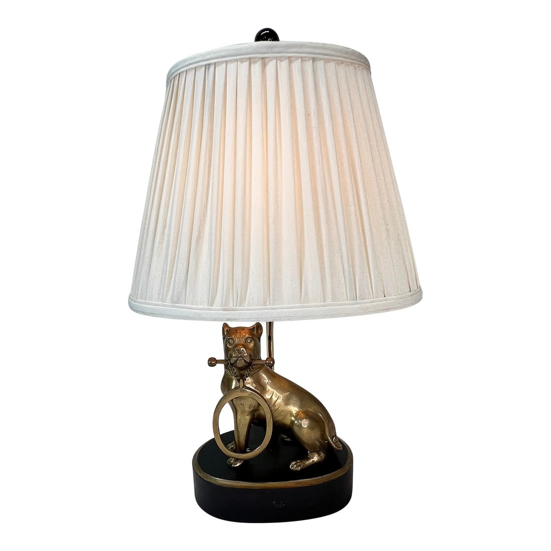 Brass Bulldog Holding Picture Frame Figure Lamp: Table lamp with brass bulldog figure mounted on black base. The bulldog holds a bar with picture frame in his mouth. Lamp measures 7.5" w x 9" d x 19" h to top of harp, 21" to top of finial. Dog