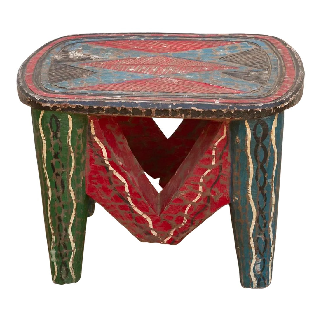 Handcarved Nupe Fiesta Small Table: A unique piece of African art, this vintage Nupe table from Nigeria is a must-have for collectors and enthusiasts of Nupe culture. Carved from a single log of wood and standing on 6 chunky tapered
