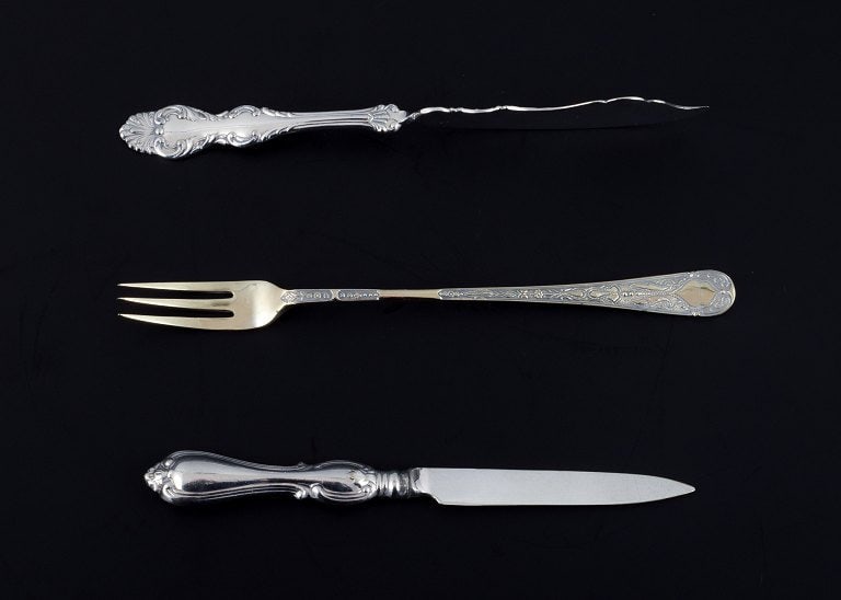 A collection of older silver cutlery consisting of fruit knife, fish knife, two sardine forks and - 3
