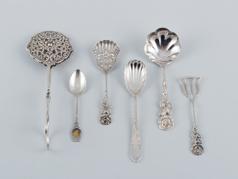 A collection of 6 pieces of various silver and new silver. Sandwich tong, spoons and more. (1 of 9)