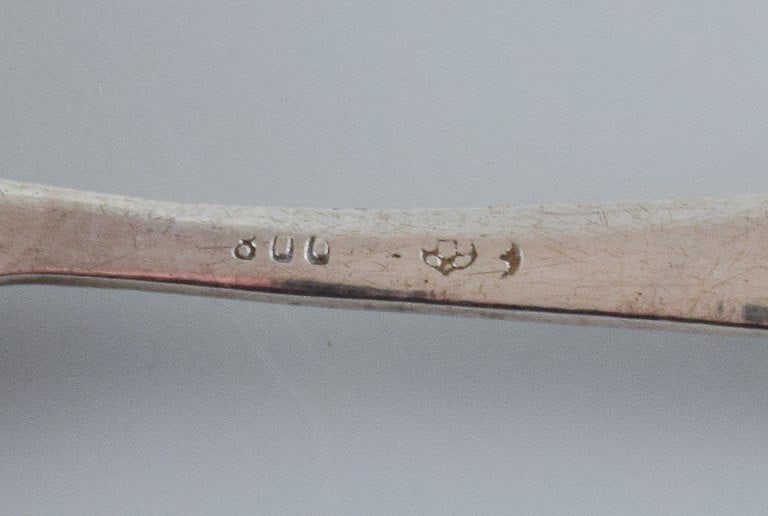 A collection of three silver spoons. - 5