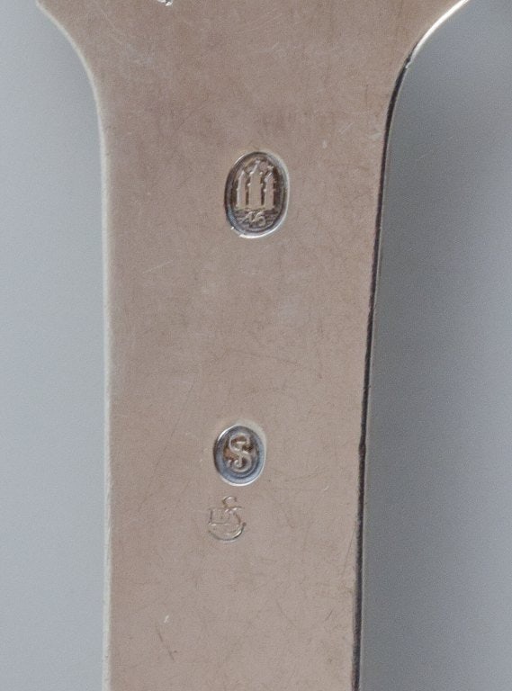 A collection of three silver spoons. - 6