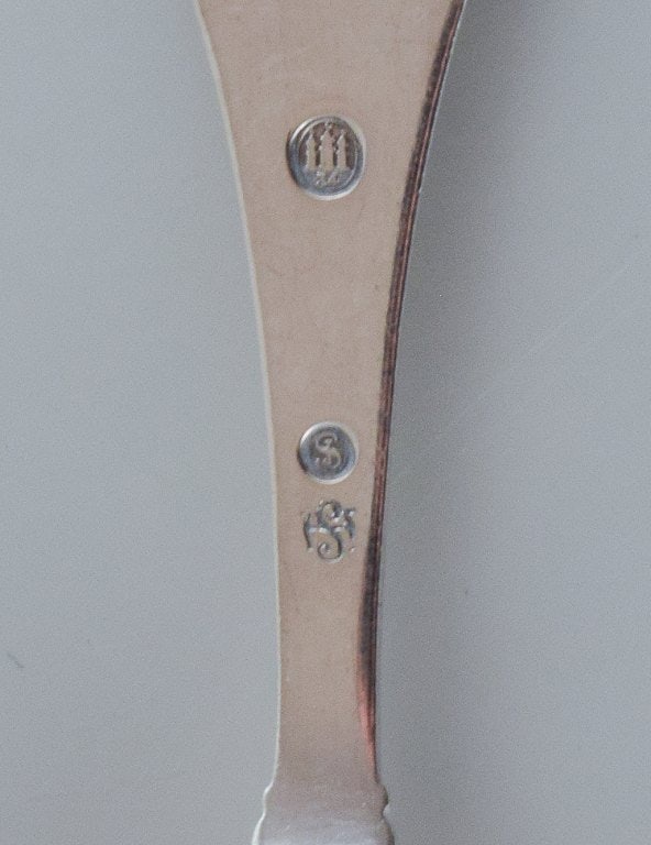 A collection of three silver spoons. - 7