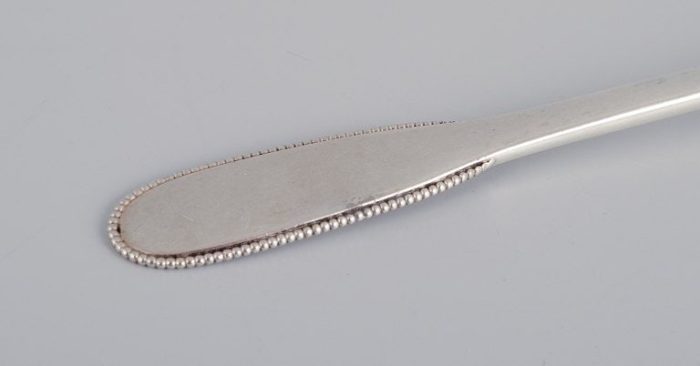 Evald Nielsen, Danish silversmith, two hammered sugar spoons in Danish 830 silver. One spoon model - 4