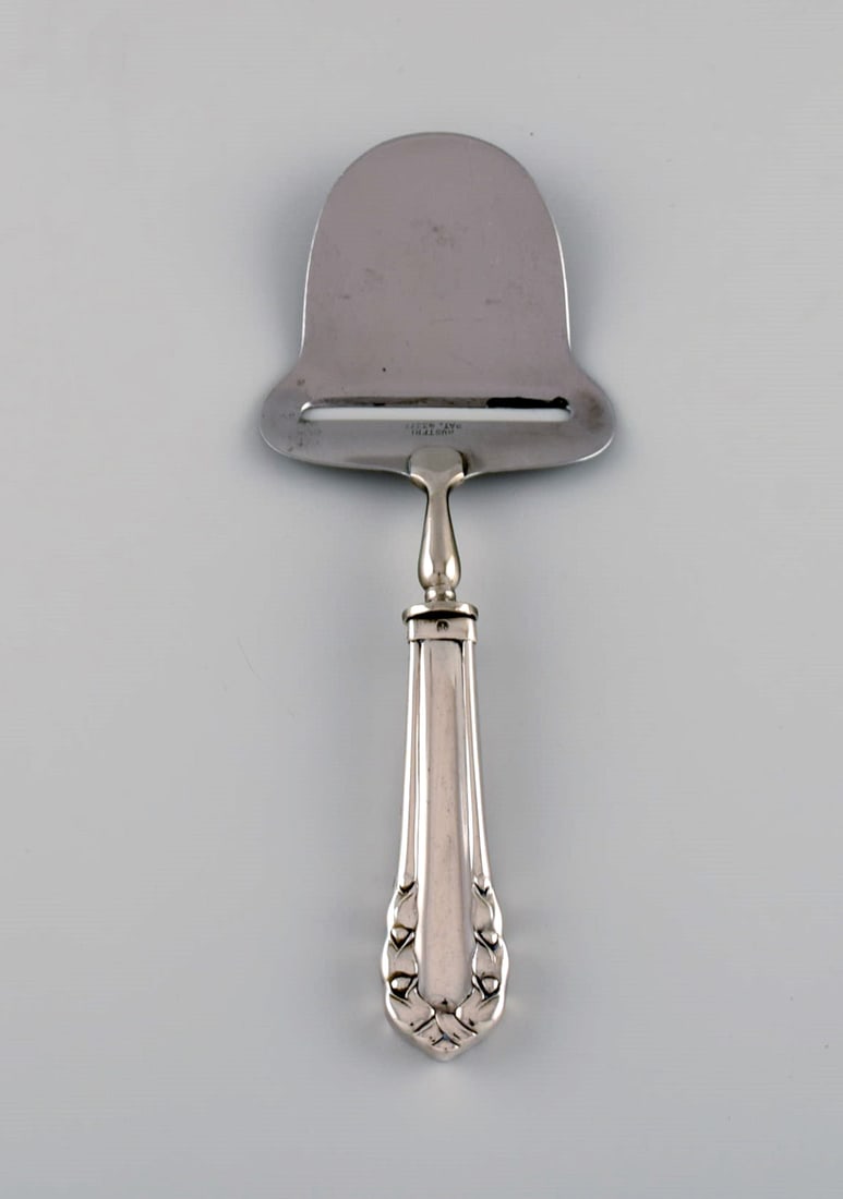 Early Georg Jensen Lily of the valley cheese slicer in silver (830) and stainless steel. Dated: Title:Early Georg Jensen Lily of the valley cheese slicer in silver (830) and stainless steel. Dated 1915-1930. Description:Early Georg Jensen Lily of the valley cheese slicer in silver (830) and stai