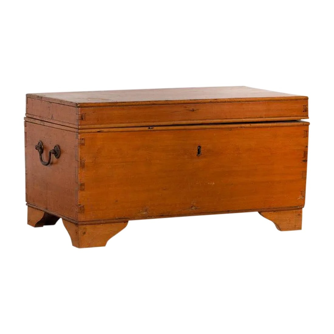 20th Century Asian Wooden Trunk: An Indonesian antique wooden blanket chest from the early 20th century, with red lacquered interior lid, lateral handles and bracket feet. Born in Indonesia during the early years of the 20th century,