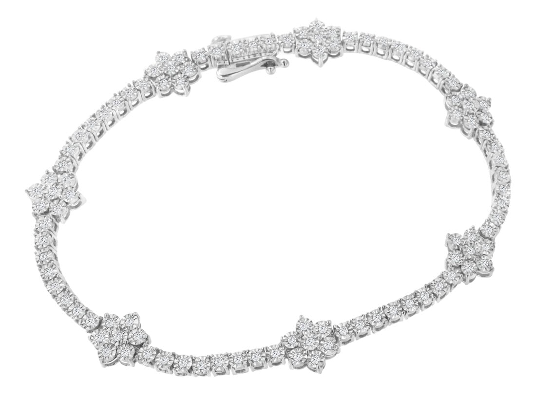 .925 Sterling Silver 1.0 cttw Miracle-Set Diamond Floral Station Tennis Bracelet (I-J Color, I3 Clar: Elegant and timeless, this gorgeous sterling silver floral link bracelet features 1.0 carat total weight of round cut diamonds. The tennis bracelet features round, flower shaped cluster links along