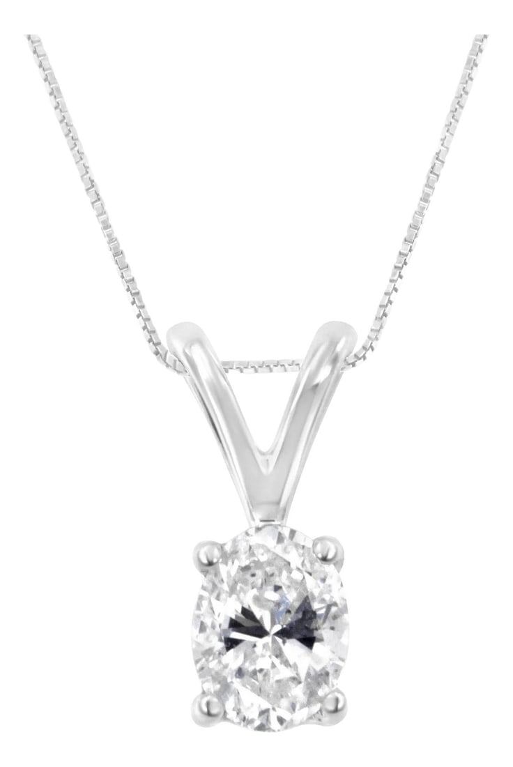 IGI Certified 10KT White Gold Diamond Oval Pendant Necklace (1/5 cttw, H-I Color, I1): A brilliant 1/5ct oval cut diamond is highlighted in this classic four prong pendant. The pendant delicately hangs from a rolo chain. This 10k white gold necklace is perfect for any occasion. 