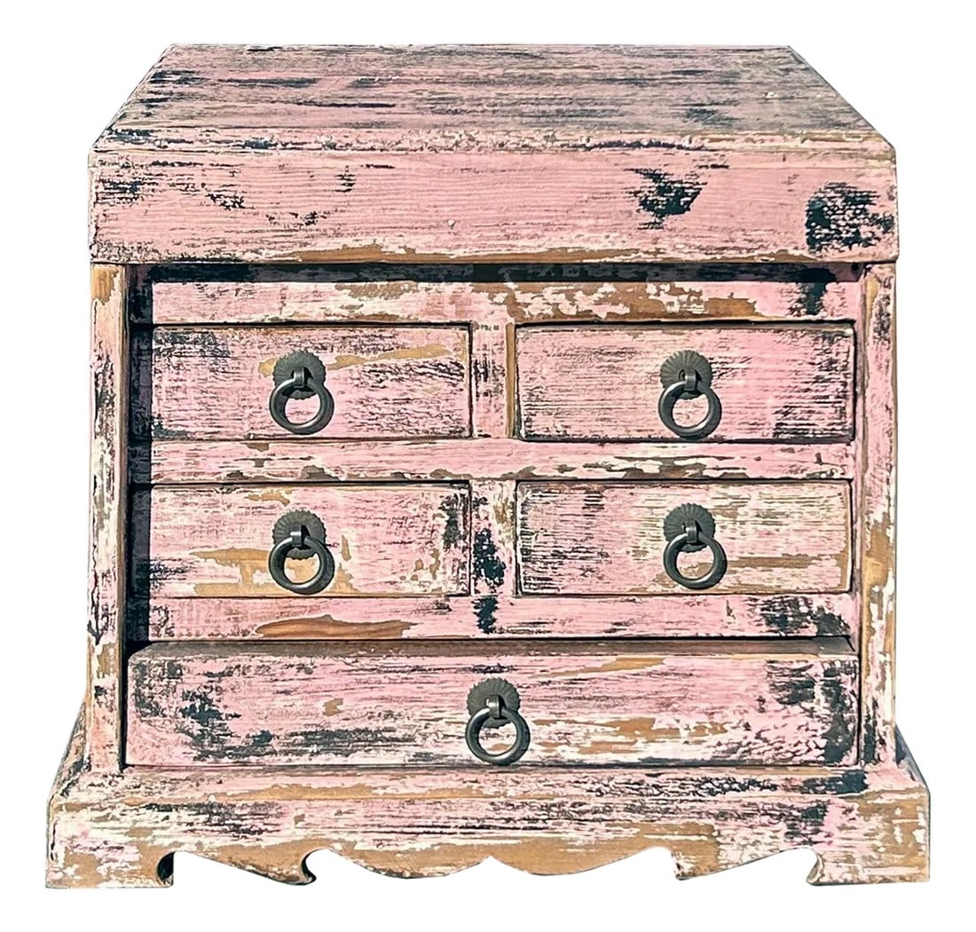 14" Distressed Faded Pink Small 5 Drawers Storage Chest Box: This image features a small, vintage wooden cabinet with a distinctly distressed appearance, exuding rustic charm. The cabinet is painted in a faded pink hue, though the paint has peeled and chipped