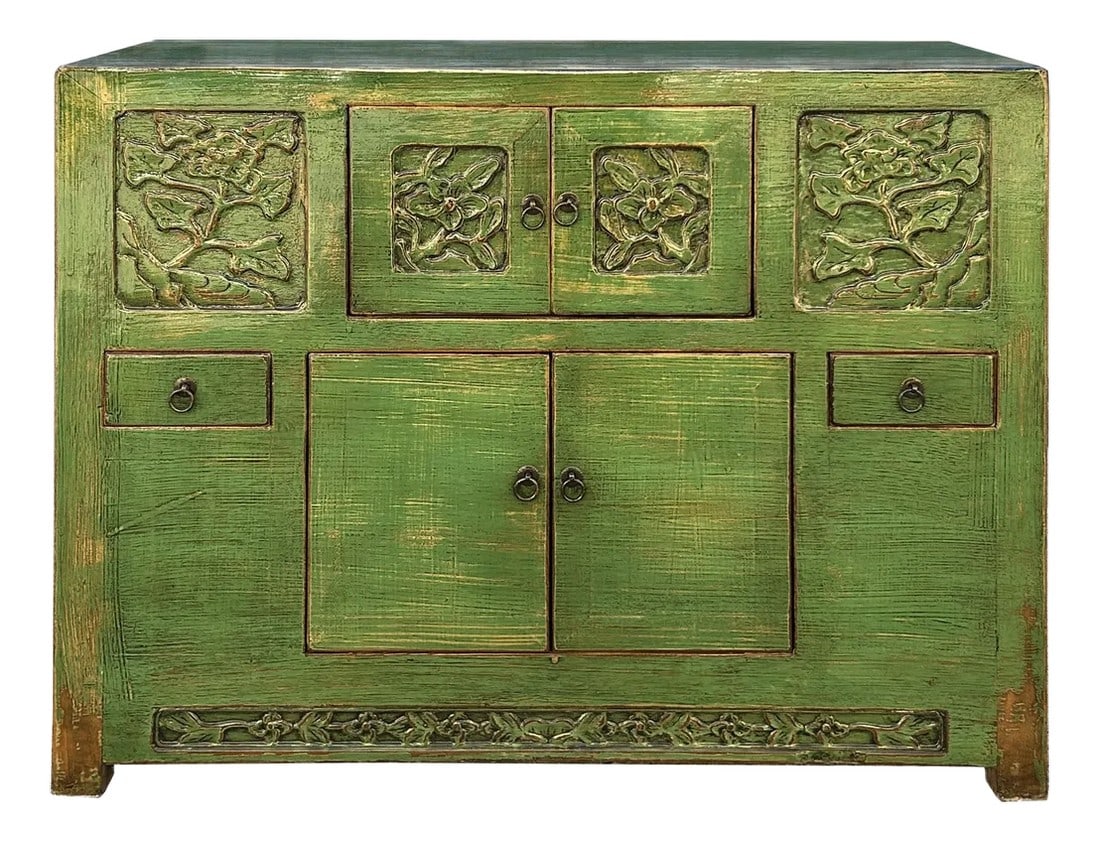 Oriental Distressed Lime Green Floral Carving Credenza Storage Cabinet: This antique green cabinet exudes a rustic charm, showcasing a weathered patina that hints at its rich history. Crafted from solid wood, its surface is adorned with intricate carvings of floral