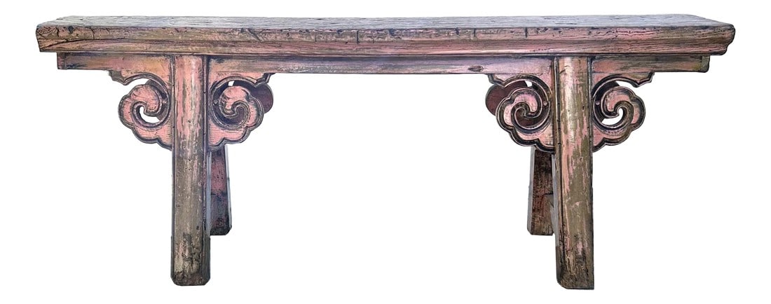 Distressed Rustic Pink Village Scroll Apron Slim Narrow Wood Bench: This antique wooden bench radiates a sense of history and craftsmanship with its intricately designed structure. The bench features a long, rectangular seat made of weathered wood, its surface marked
