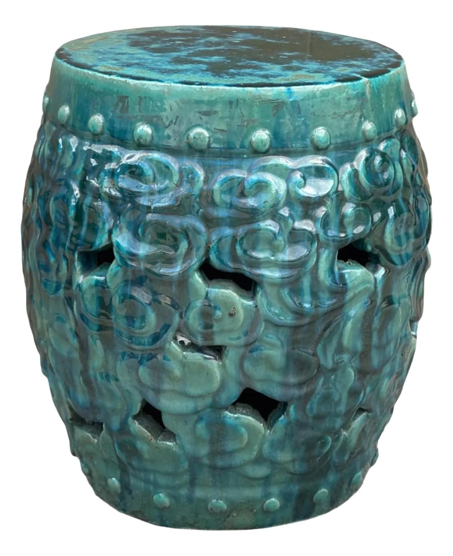 Green Teal Turquoise Swirl Cloud Pattern Round Ceramic Stool Table: The stool is crafted from a glazed ceramic material, showcasing a rich, teal-green hue with darker striations creating a mottled effect. Its surface is adorned with a repeating pattern of raised,