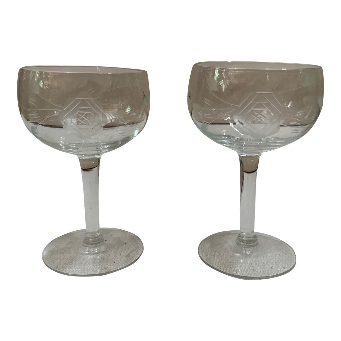Pair of 1970s Champagne Glasses With Geometric Rose Designs: Up for consideration is a beautiful pair of champagne glasses with geometric rose designs. These would look lovely in your home and they are a great find for the interior design enthusiast. Please