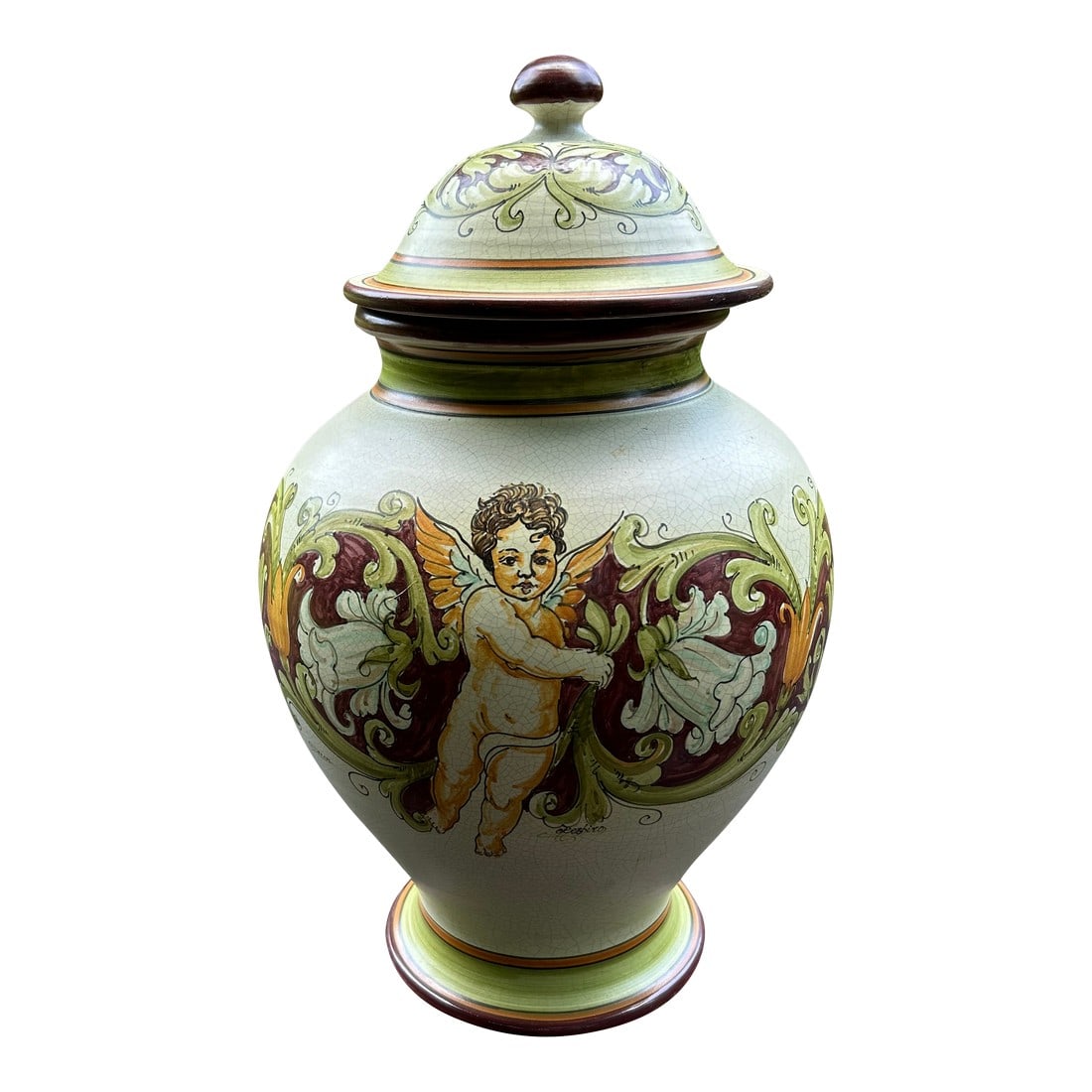 Calabrian Italian Ceramic Lidded Urn With Cherub: Large romantic hand painted ceramic lidded urn from Calabria Italy featuring cherub and foliage in earth colors against a cream background. Found in an antique store abroad about 25 years ago. 