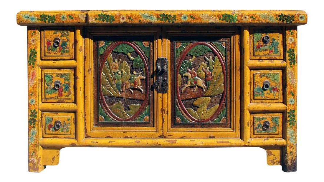 Chinese Distressed Yellow Carving Motif Tv Console Table Cabinet: This is a low console sideboard cabinet with oriental colorful relief carving of people graphic on the doors. The surface is finished with rustic distressed yellow color. It is a charming piece as a