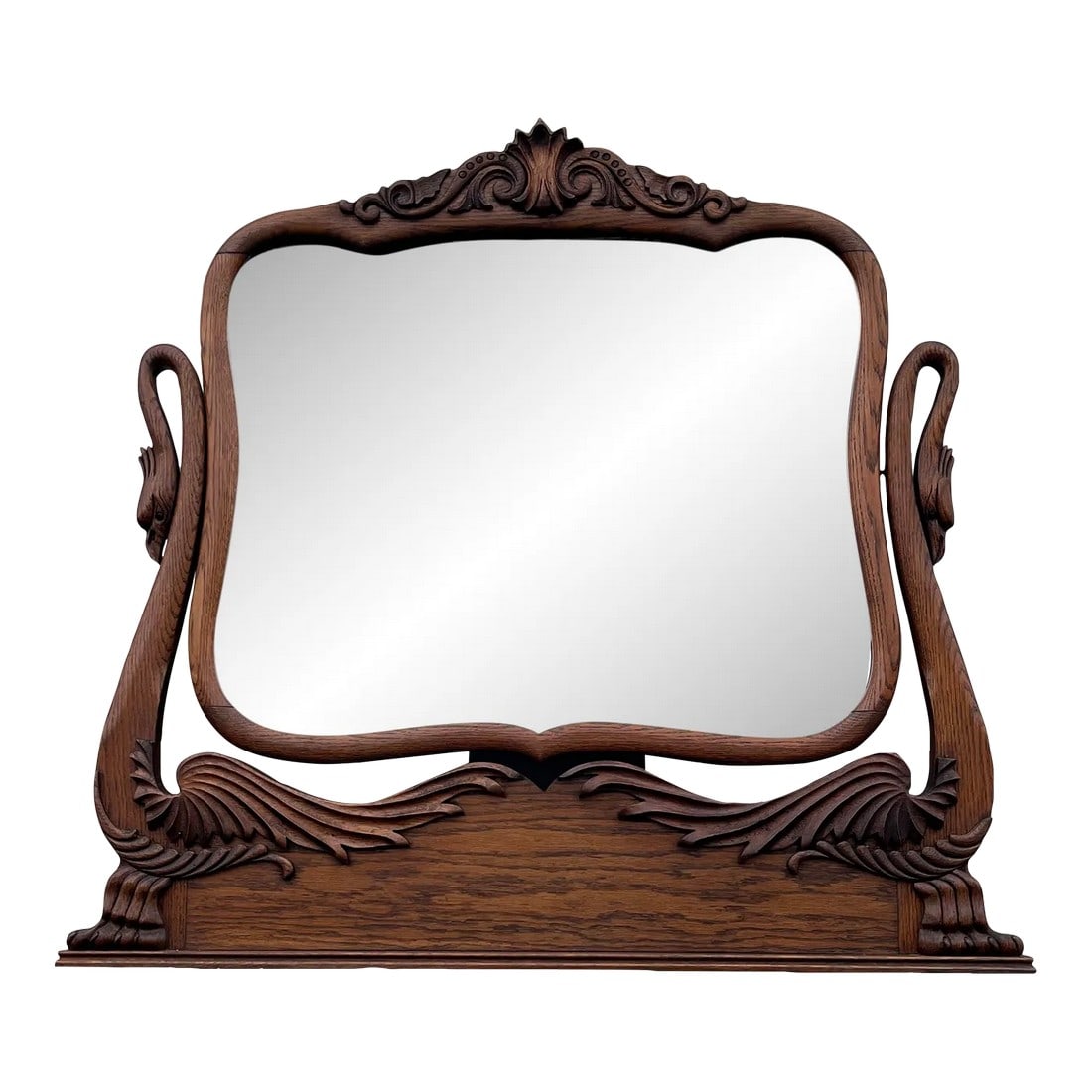Antique Carved Swans Articulating Beveled Glass Oak Dressing Mirror: An early American dressing mirror from the early 1900's. Features an articulating design with carved swans on either end. For original use as a dresser top mirror, the stabilization slats to attach st