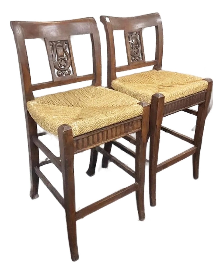 Pair of 1980s Hand Carved Mahogany Bar Stools: Solid pair of hand carved mahogany bar stools in the provencal style, rushed seating surface and lyre motif back splats. Photos are pre-waxing so they'll have an even deeper glow. Sturdy and