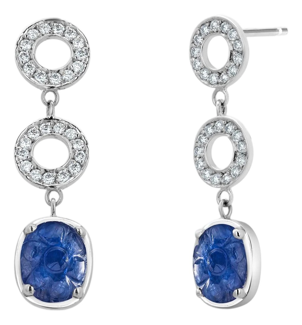 Diamond Circle Drop Gold Earrings With GIA-Certified No-Heat Burma Sapphires, A Pair: A striking fusion of rarity, elegance, and modern glamour, these 14K White Gold Diamond Circle Drop Earrings feature two intricately carved Burma sapphires totaling 5.22 carats, accompanied by a GIA