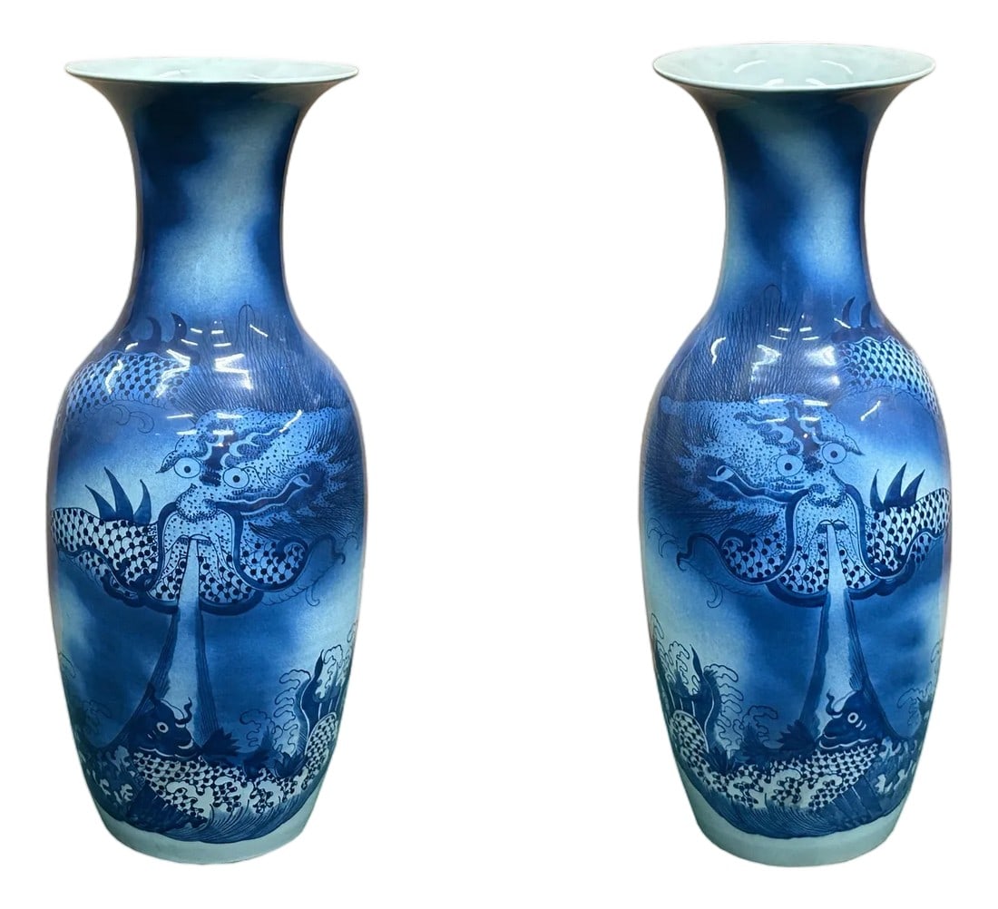 Pair Deep Blue Dragon Koi Fish Graphic Tall Porcelain Art Vases: This striking pair of blue and white vases is a breathtaking example of traditional artistry, featuring a majestic dragon amidst roiling waves. The intricate details of the dragon, from its fearsome