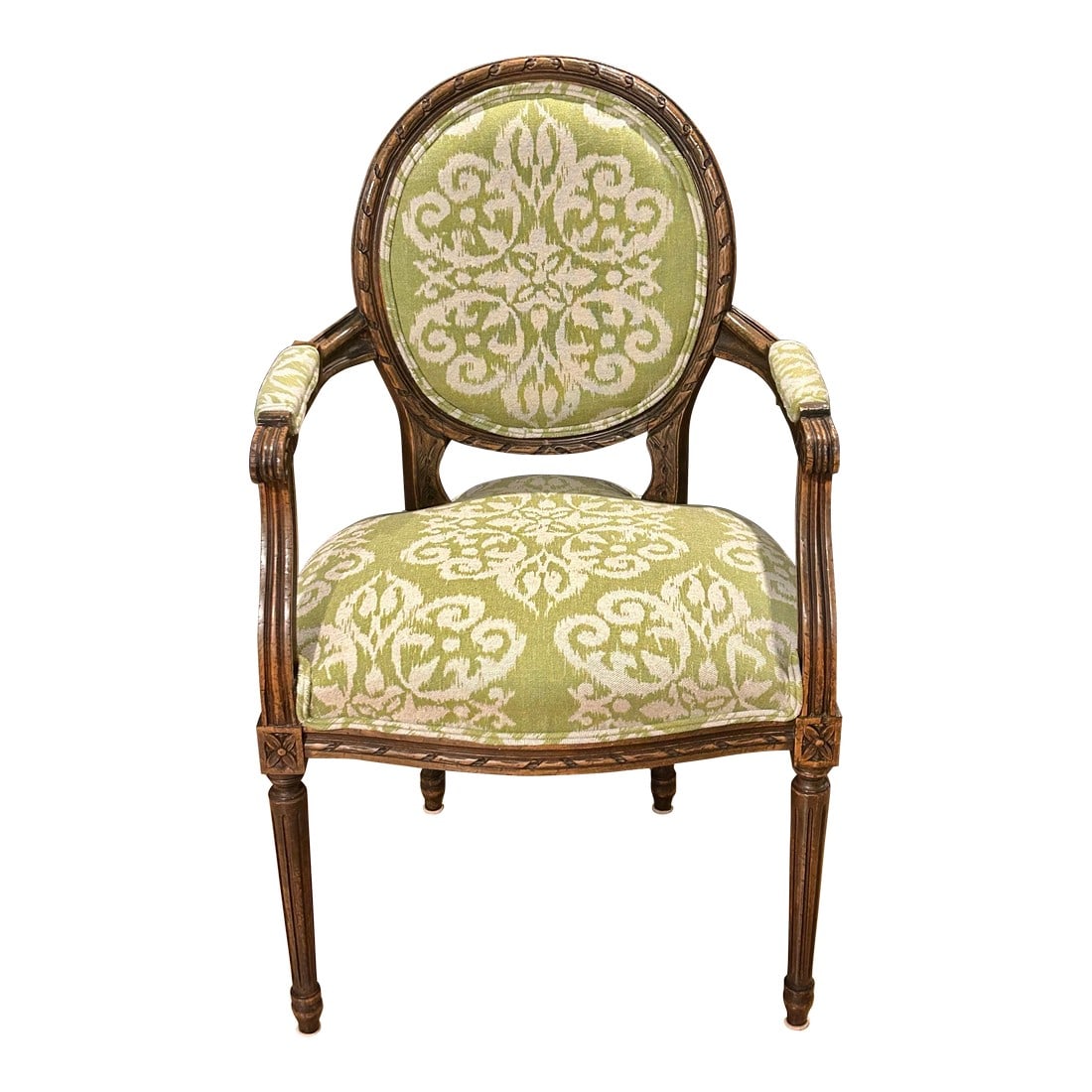 Early 20th Century Louis XVI Fauteuil French Style Armchair: This vintage (possibly antique) Louis XVI fauteuil has a medallion back which is beautifully carved. The fluted tapered legs sport carved rosettes and the arms have scroll ends. The upholstery is a