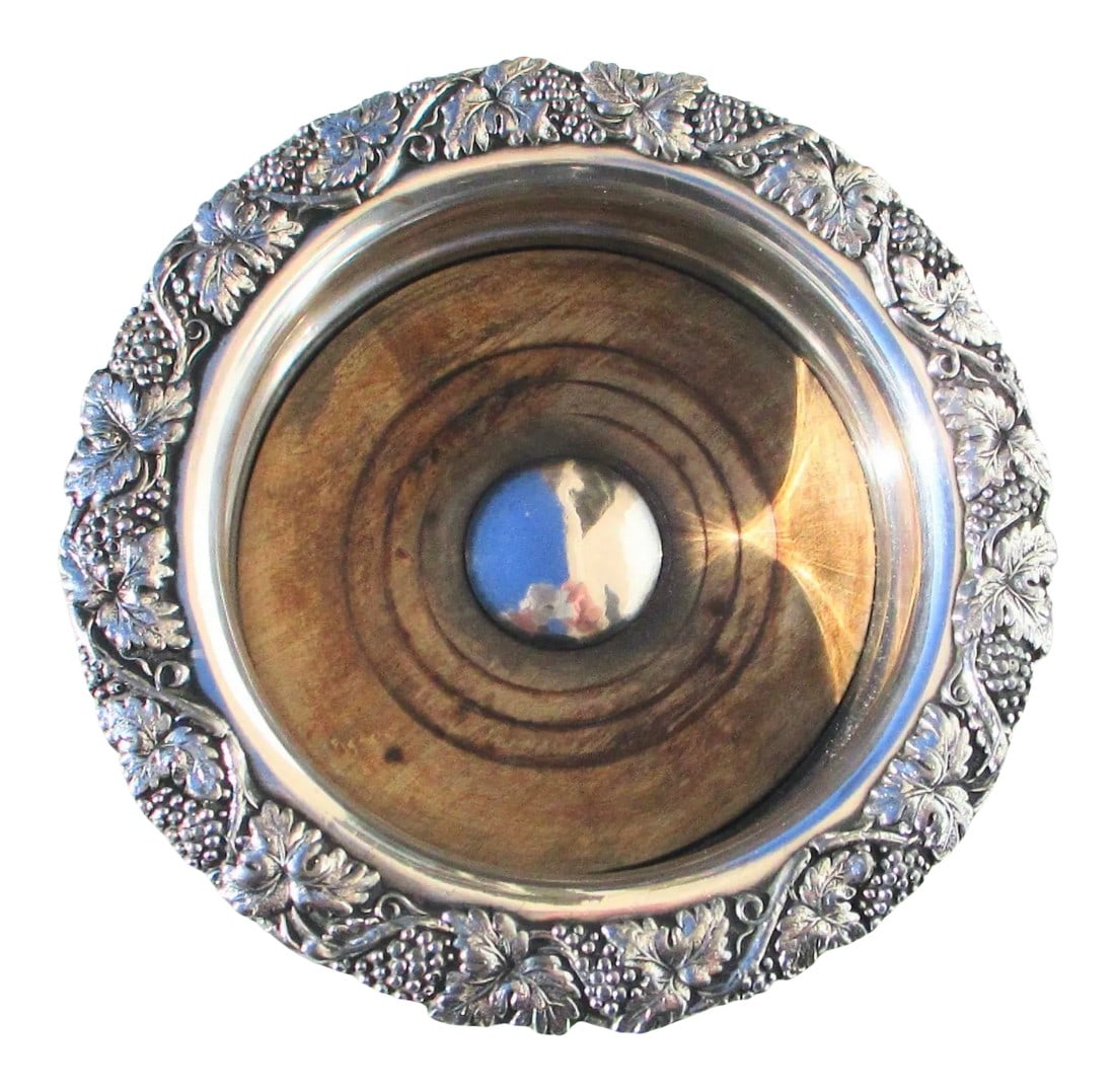 19th Century Old Sheffield Plate Wine Coaster.: Old Sheffield Plate. Highly decorated shallow bottle holder with wooden insert for moisture forming on chilled bottles. Impressively modeled band of grapes and leaves scroll around the rim. The size