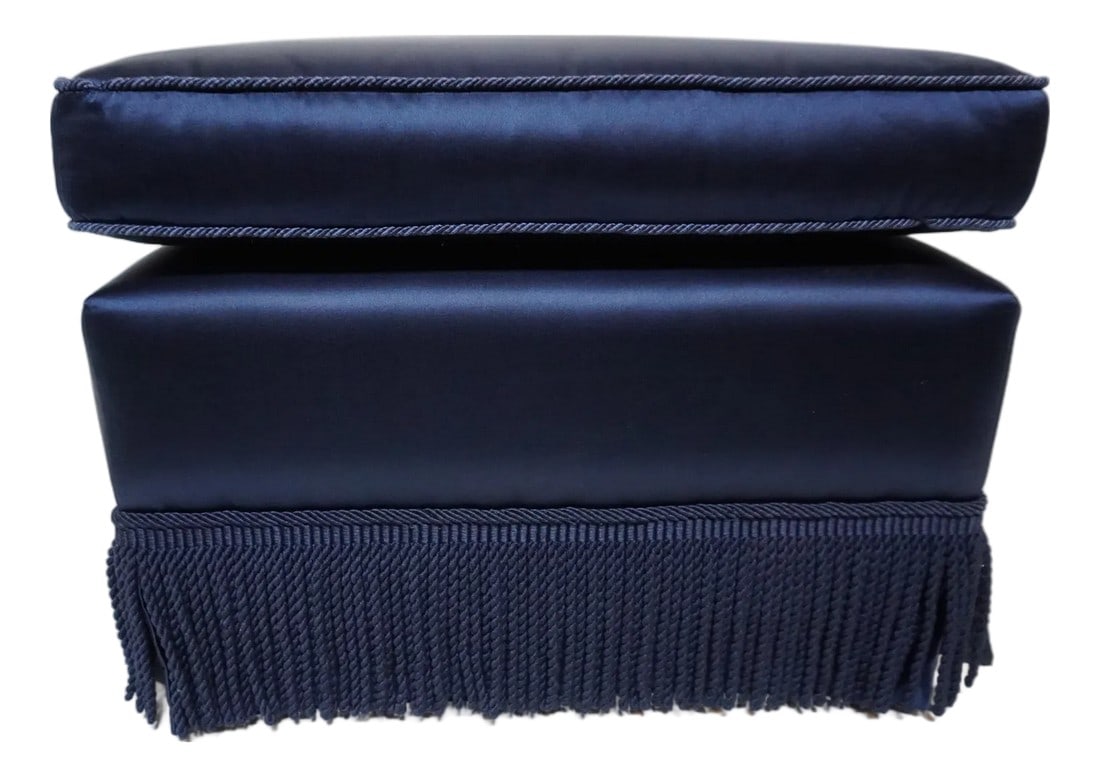 Late 20th Century Blue Ottoman With Fringed Skirt: Blue Ottoman With Fringed Skirt Beautifully upholstered in a striking blue satin material with braid piping in a matching color and a bullion fringe skirt over fabric. The design blends classic