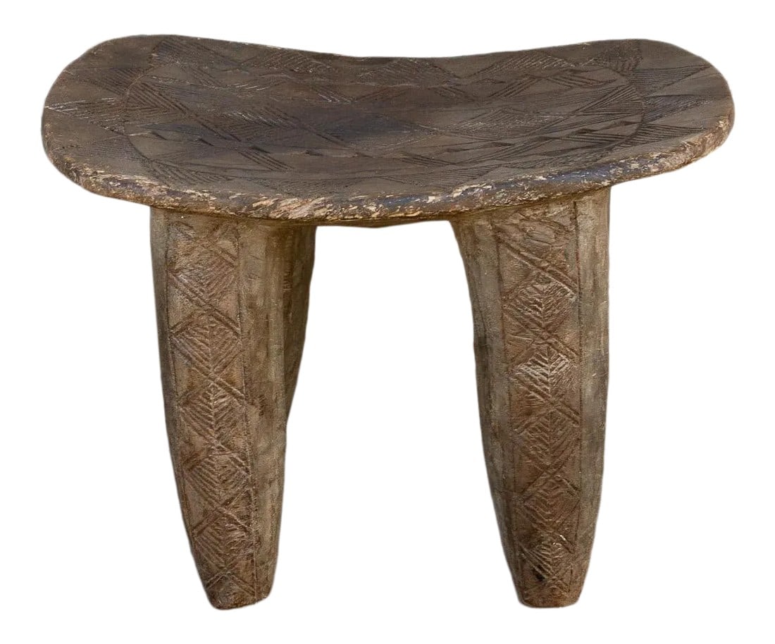 African Geometric Motif Senufo Side Table: An antique tribal carved senufo table with a concave top that can be used as a side table or as a stool. It features a hand-carved with geometric designs. This antique table is carved from a single lo