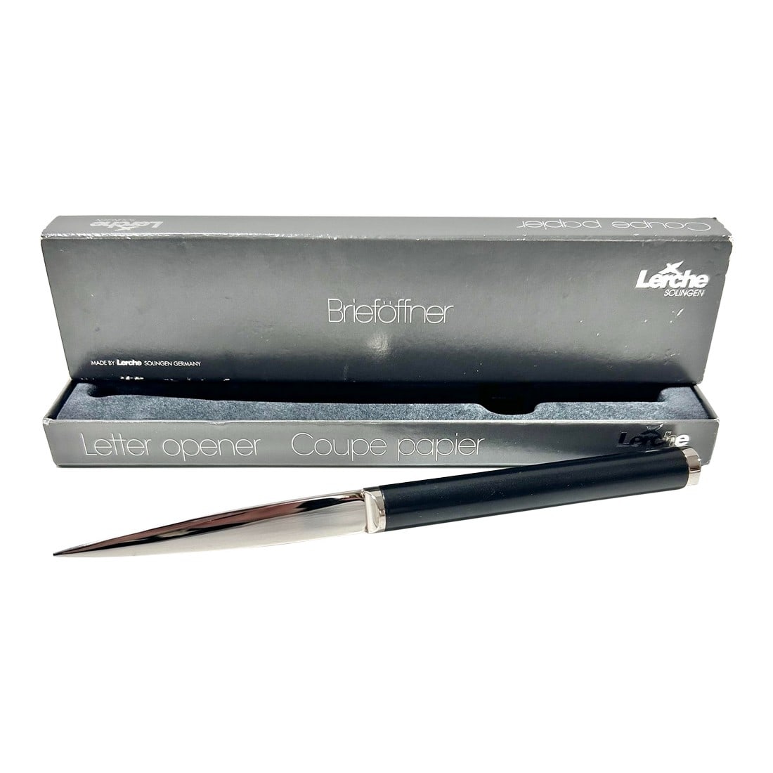 1980s Lerche Solingen Germany Letter Opener, Boxed: This sleek Lerche Solingen letter opener features a highly polished stainless-steel blade paired with a smooth black handle, reflecting the precision and craftsmanship Solingen is known for. Its
