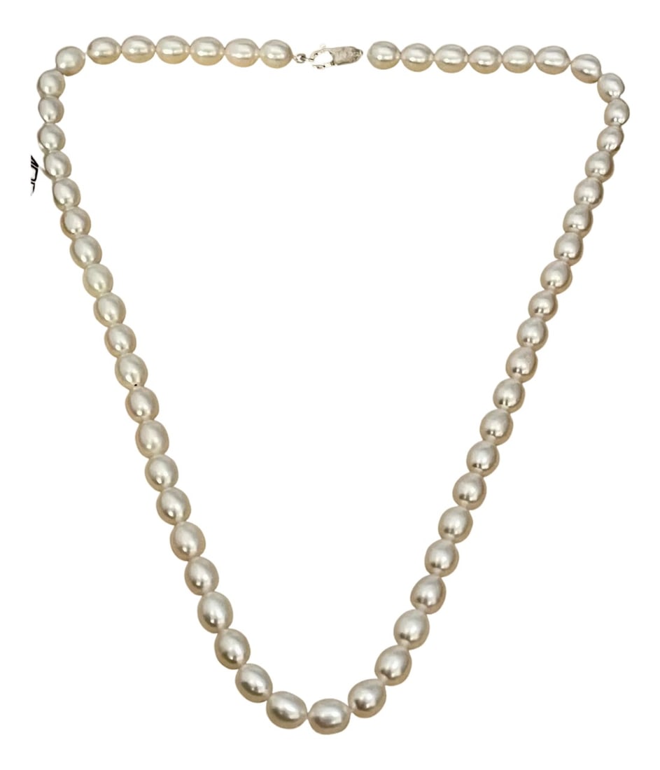 Fresh Water Elongated Pearl Single Strand Necklace, Silver Clasp: Fresh Water Elongated Pearl Single Strand Necklace Length 16", Silver Clasp measuring approx. 6 to 6.5 mm Cream to white color Length of Strand including clasp 16 Inch PEARLS ARE AVERAGE 6 MM ALL