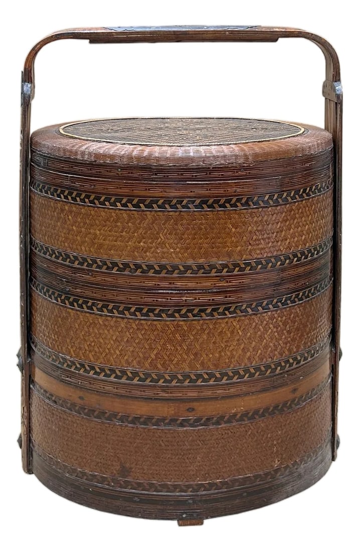 Vintage Oriental Handmade Brown Rattan Stack Basket With Handle: This is a beautiful vintage Chinese stacking basket, crafted primarily from warm-toned, reddish-brown rattan and bamboo. The piece is cylindrical and consists of multiple fitted trays stacked
