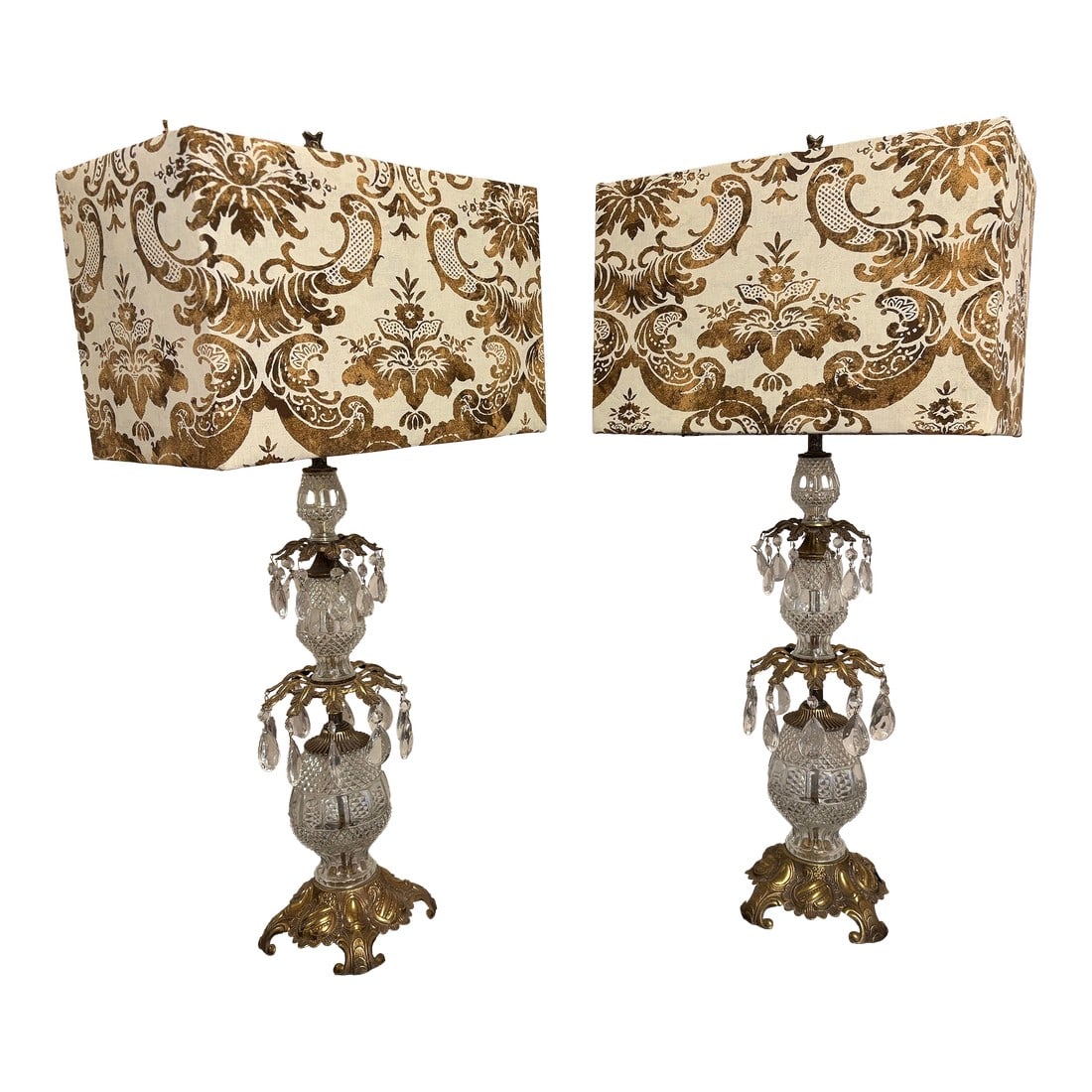 1950s Hollywood Regency Hand Stamped Austrian Lamps Wifh Fortuny Fabric Lamp Shades, a Pair: The Hollywood Regency vintage Austrian crystal lamps with vintage hand stamped Fortuny fabric are quite stunning and make such a sticking pair that a person is taken aback by the beauty of them. 