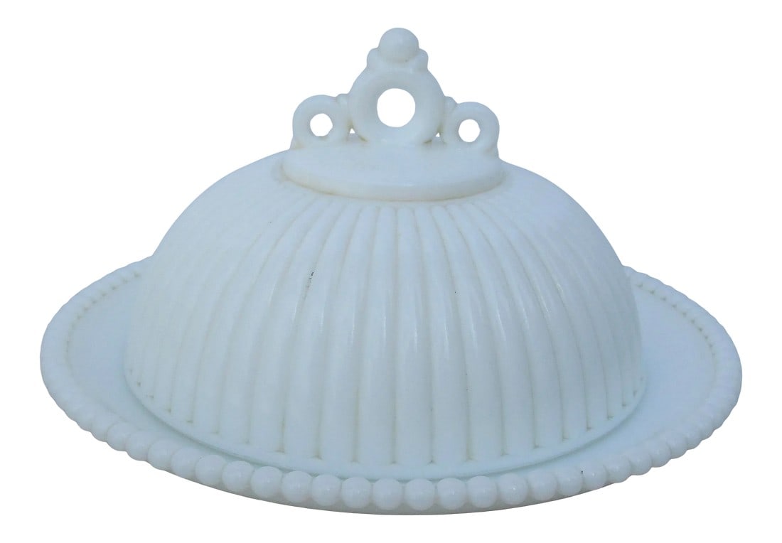 Antique Milk Glass Art Deco Butter Dish: Art Deco designed milk glass covered butter dish with deco design finial handle. Very elegant deco refinements with a very homey material, milk glass. The ribbed lid over a plate with a beaded rim.