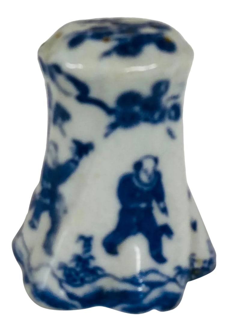 Late 20th Century Chinoiserie Salt Shaker: Single blue and white chinoiserie salt or pepper shaker features a scalloped bottom and 13 holes in the top. Has a lovely scene of chasing butterflies. Condition: Alterations: Original Condition