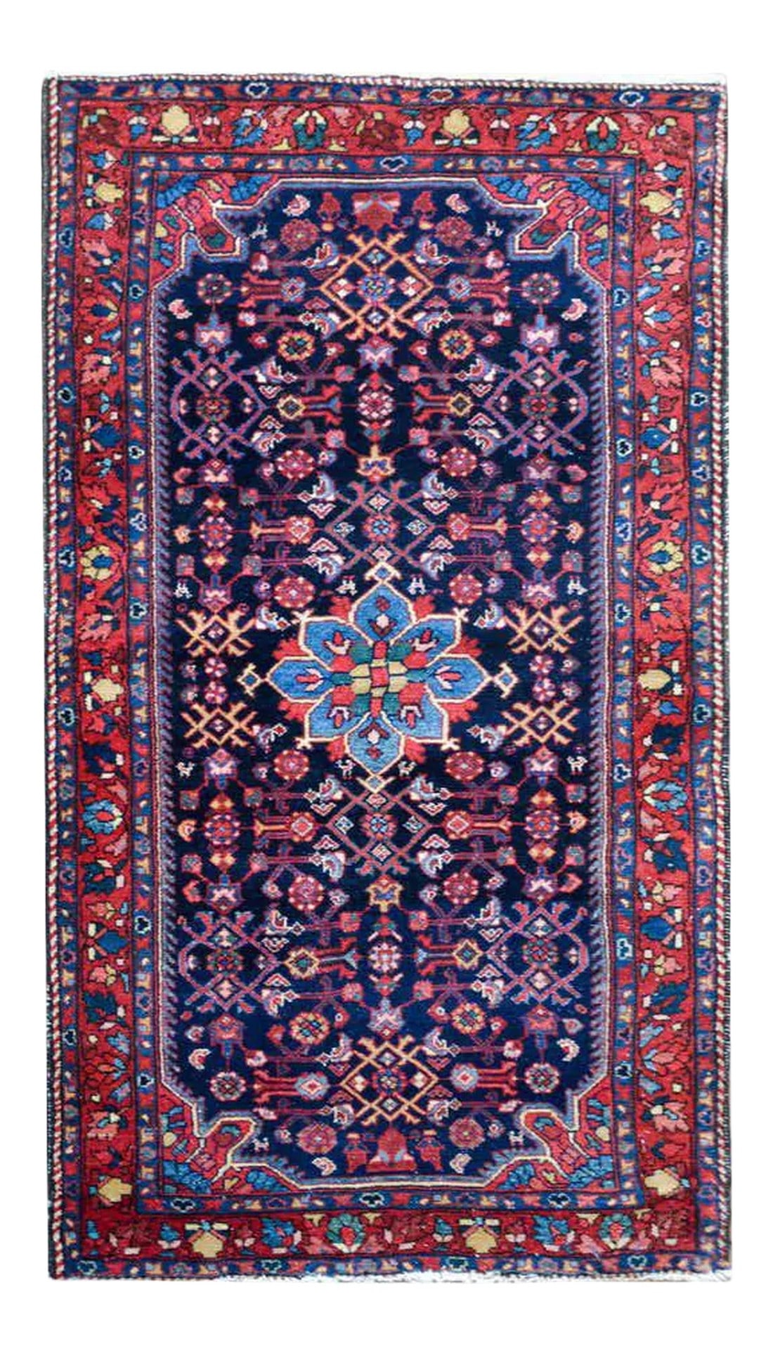 Early 20th Century Bibikibad Rug: A striking early 20th century Persian Bibikibad rug with an all-over stylized floral and scrolling vine pattern woven in crimson, light and dark indigo, gold, and white against a dark indigo