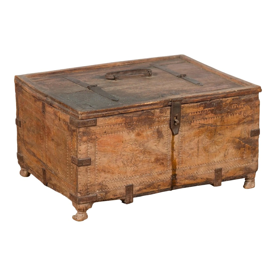 19th Century Rustic Indian Carved Rosette Small Foot Treasure Box: A rustic Indian antique wooden treasure box from the 19th century, with iron braces, carved rosettes and petite feet. Created in India during the 19th century, this wooden box features a rectangular l