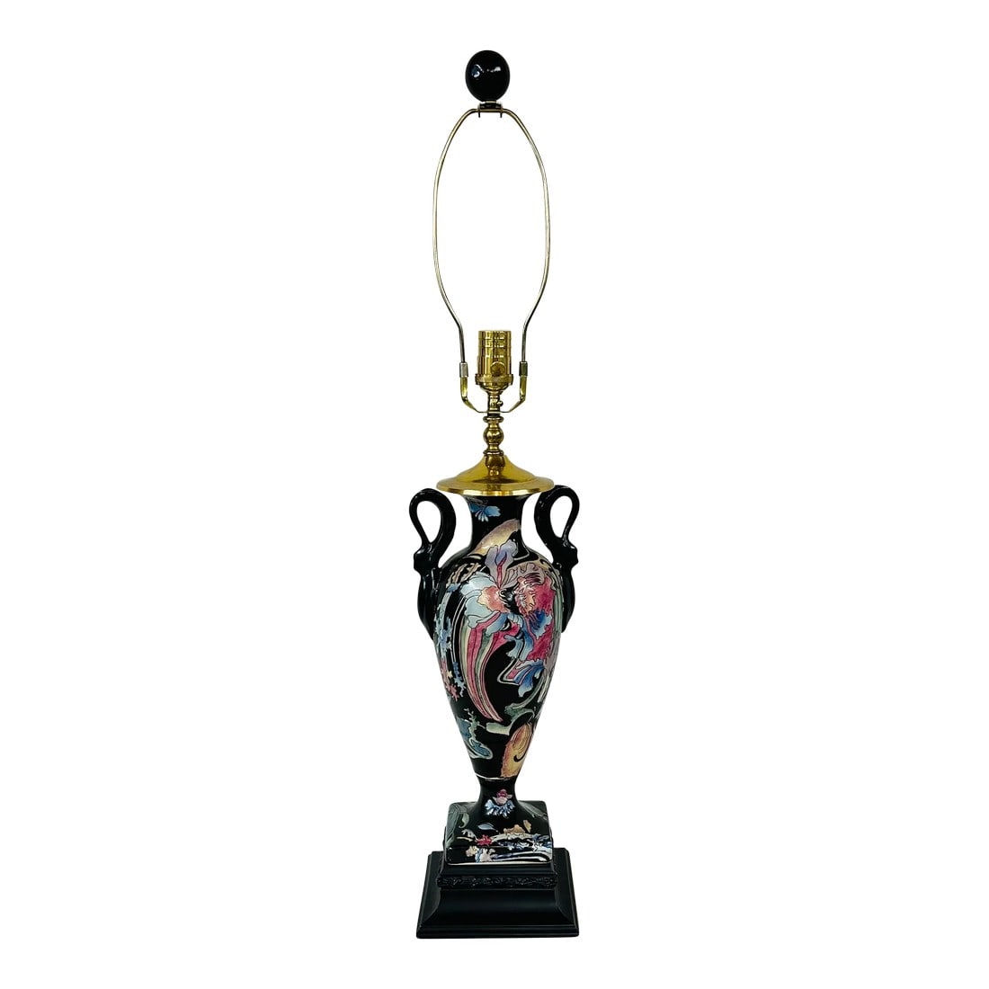 Chinoiserie Style Lamp by Heyward House: Heyward House table lamp features heavy brass components on a black ceramic center with handles and black wood riser. Floral pattern features colors of pink, lavender, blue and green. Measures 7" w x