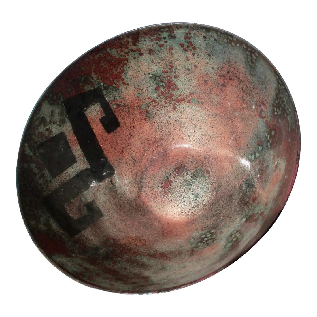 Copper Enamel Bowl Circa 80s: Decorative copper enamel bowl. Designed with a black geometric symbol on the wall and organic oxidized blues and greens over the interior walls and over the outside and bottom. The bottom is marked