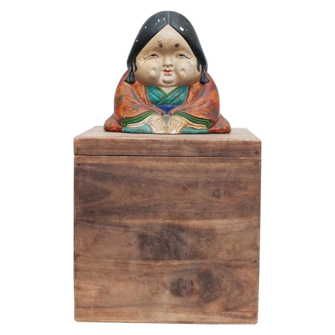 Meiji Era Otafuku Girl Figurine on Wood Stand: Mid 19th century Figurine (Doll) on wood stand. are traditional Japanese pottery dolls associated with great wealth and happiness in Japan. The doll is depicting a kneeling woman with a large head