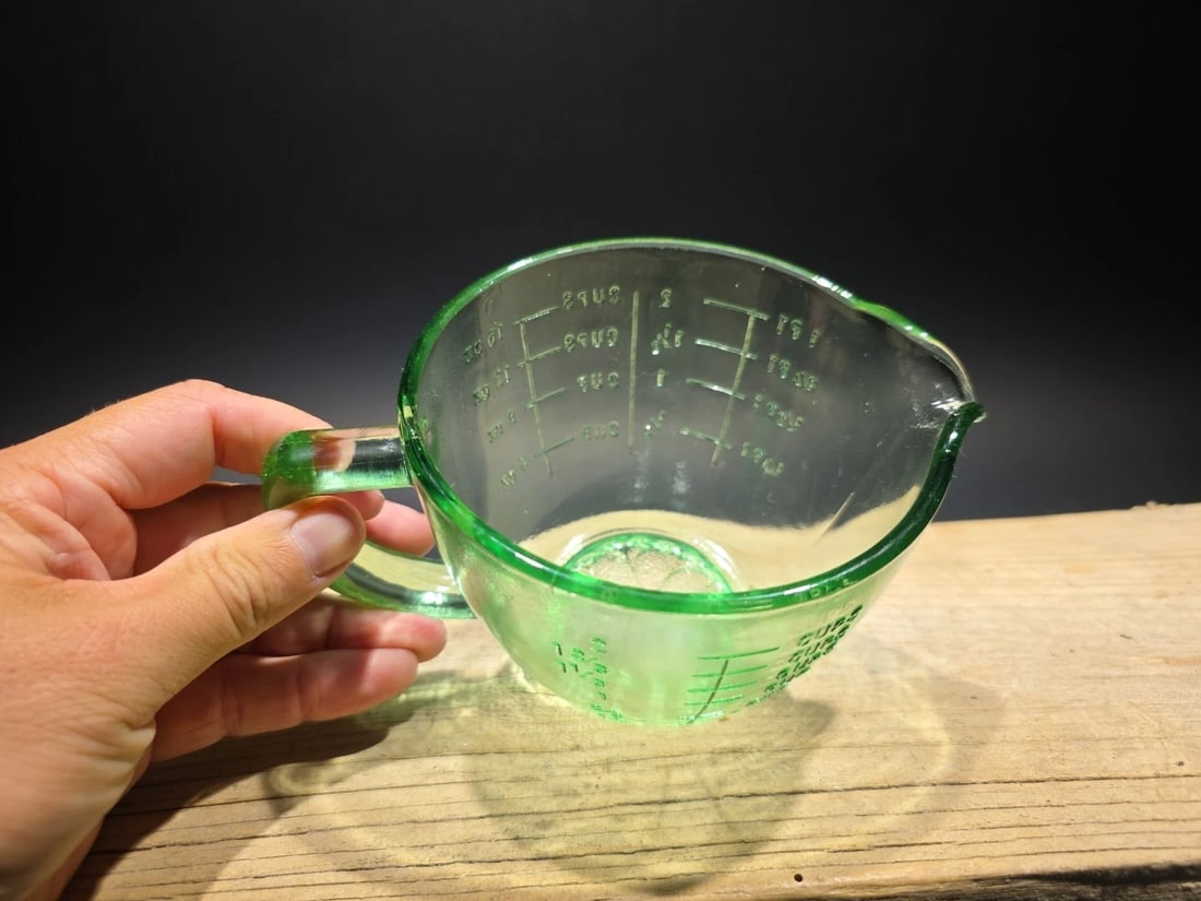 2 Cup Antique Vintage Style Green Glass Measuring Cup: Title: 2 Cup Antique Vintage Style Green Glass Measuring Cup Description: 5" Tall 2 cup measure Wonderful reproduction Green 2 cup measure. This piece is must-have for any glassware collector. The