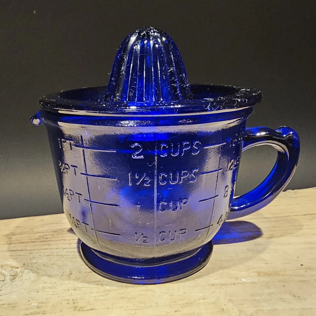 2 Cup Cobalt Blue Glass Measuring Cup Juicer Reamer Set: Title: 2 Cup Antique Vintage Style Cobalt Blue Glass Measuring Cup Juicer Reamer Set Description: 5" Tall 2 cup measure Wonderful reproduction vibrant blue 2 cup measure with matching reamer for the