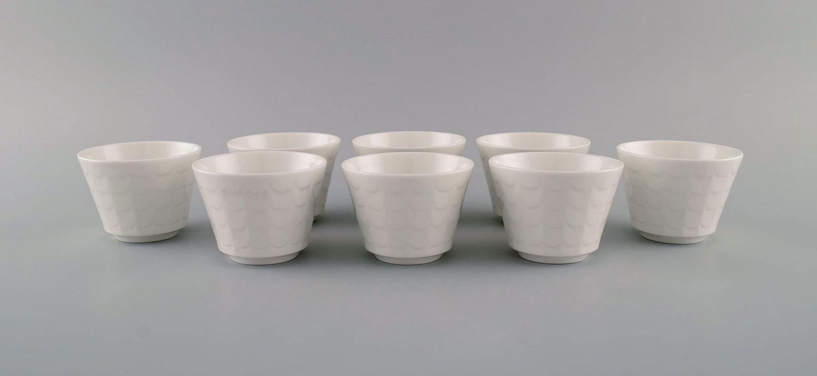 Wilhelm Kåge for Gustavsberg. Eight cups in white glazed porcelain. Swedish design, 1960s. (1 of 5)