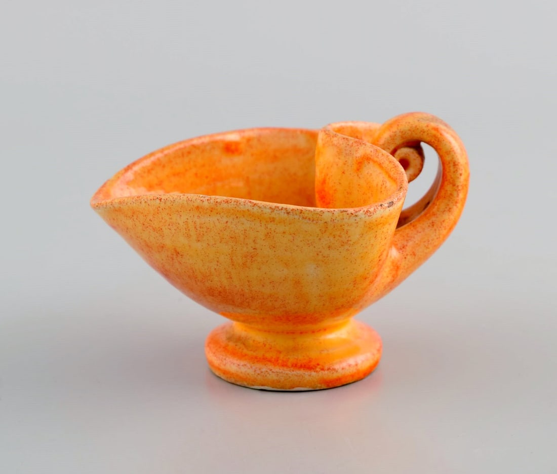 Kähler, Denmark. Cream jug in glazed stoneware. Beautiful orange uranium glaze. 1940s.: Title:Kähler, Denmark. Cream jug in glazed stoneware. Beautiful orange uranium glaze. 1940s. Description:Kähler, Denmark. Cream jug in glazed stoneware. Beautiful orange uranium glaze. 1940s