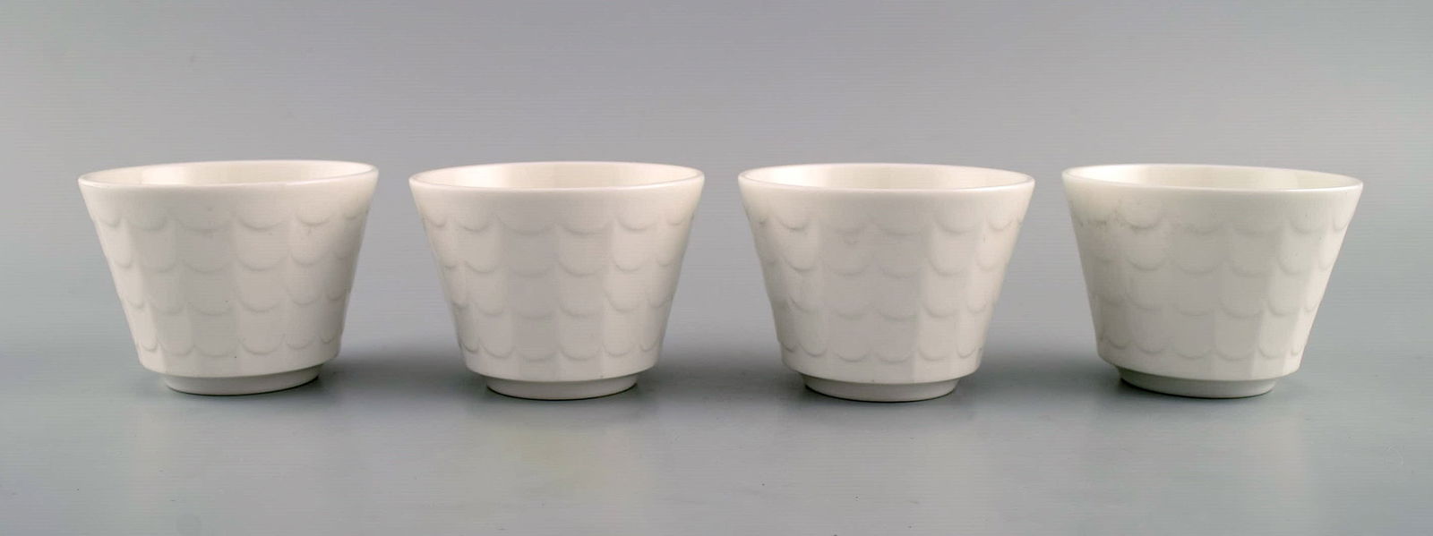 Wilhelm Kåge for Gustavsberg. Four flower pot covers in porcelain. Swedish design, 1960s. (1 of 6)
