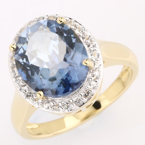 Ring: Blue Rainbow Quartz Oval 12x10mm: No Reserve! Title: Ring: Blue Rainbow Quartz Oval 12x10mm Description: Blue Rainbow Quartz Oval 12x10mm - 1Pcs + White Topaz Round 1.30mm - 26Pcs Date/Period: After 2000 Materials: 925 Silver W/Yellow