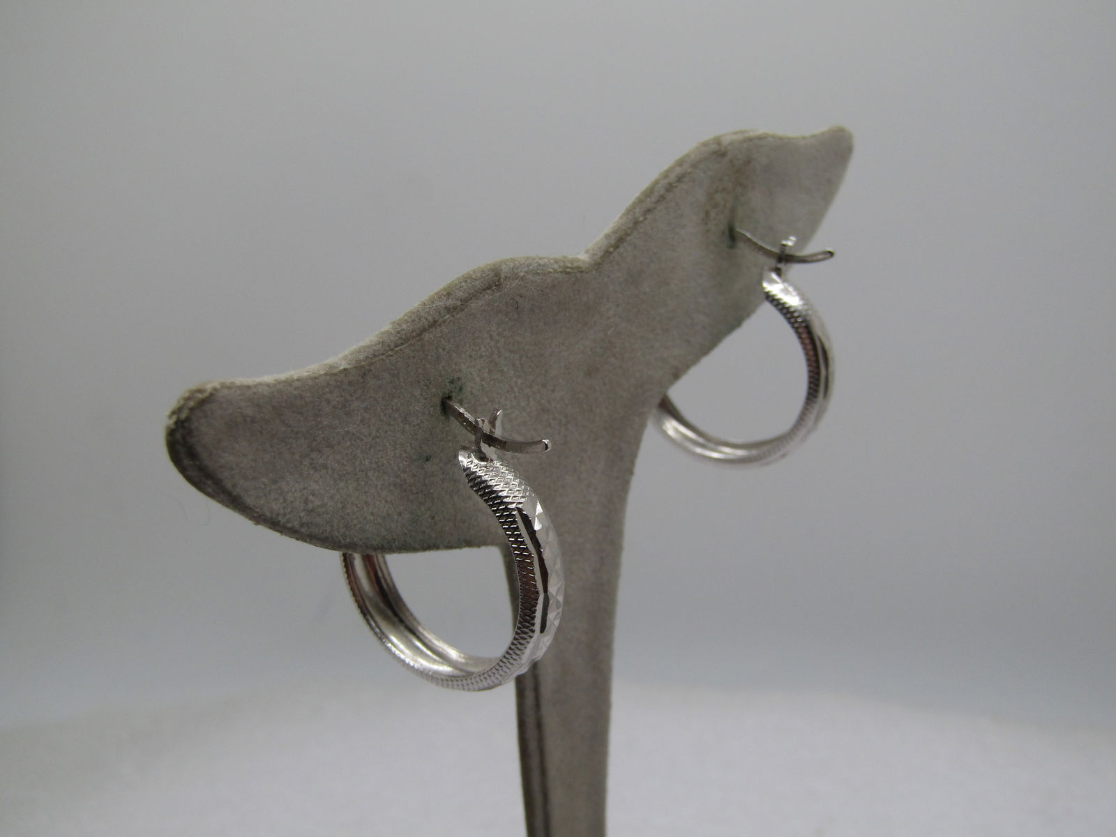 Vintage Sterling Hoop Pierced Earrings, Diamond Cut, Turkey, 1", 1990's: Vintage Sterling Hoop Pierced Earrings, Diamond Cut, Turkey, 1". 1990's. They are domed on the center edge with a diamond cut angle cut design and small etched marks on the etches. Hinged clip with