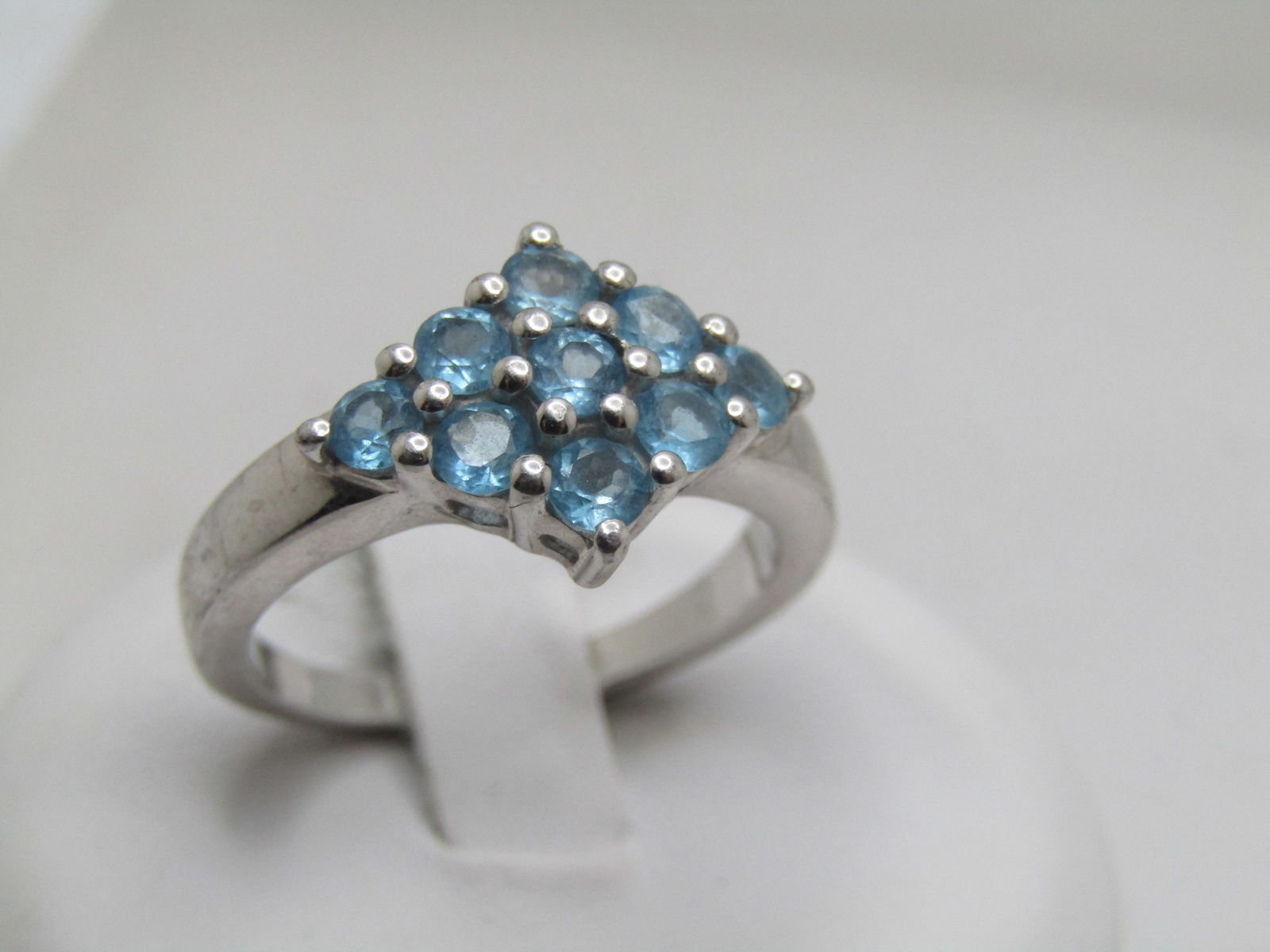 Vintage Sterling Blue Topaz Ring, Sz. 7, Diamond Shaped, Signed TGGC, 1970's-1980's: Vintage Sterling Blue Topaz Ring, Sz. 7, Diamond Shaped, Signed TGGC, 1970's-1980's. This has nine round blue topaz stones that are appx. 3mm arranged in a diamond shape with the widest point being