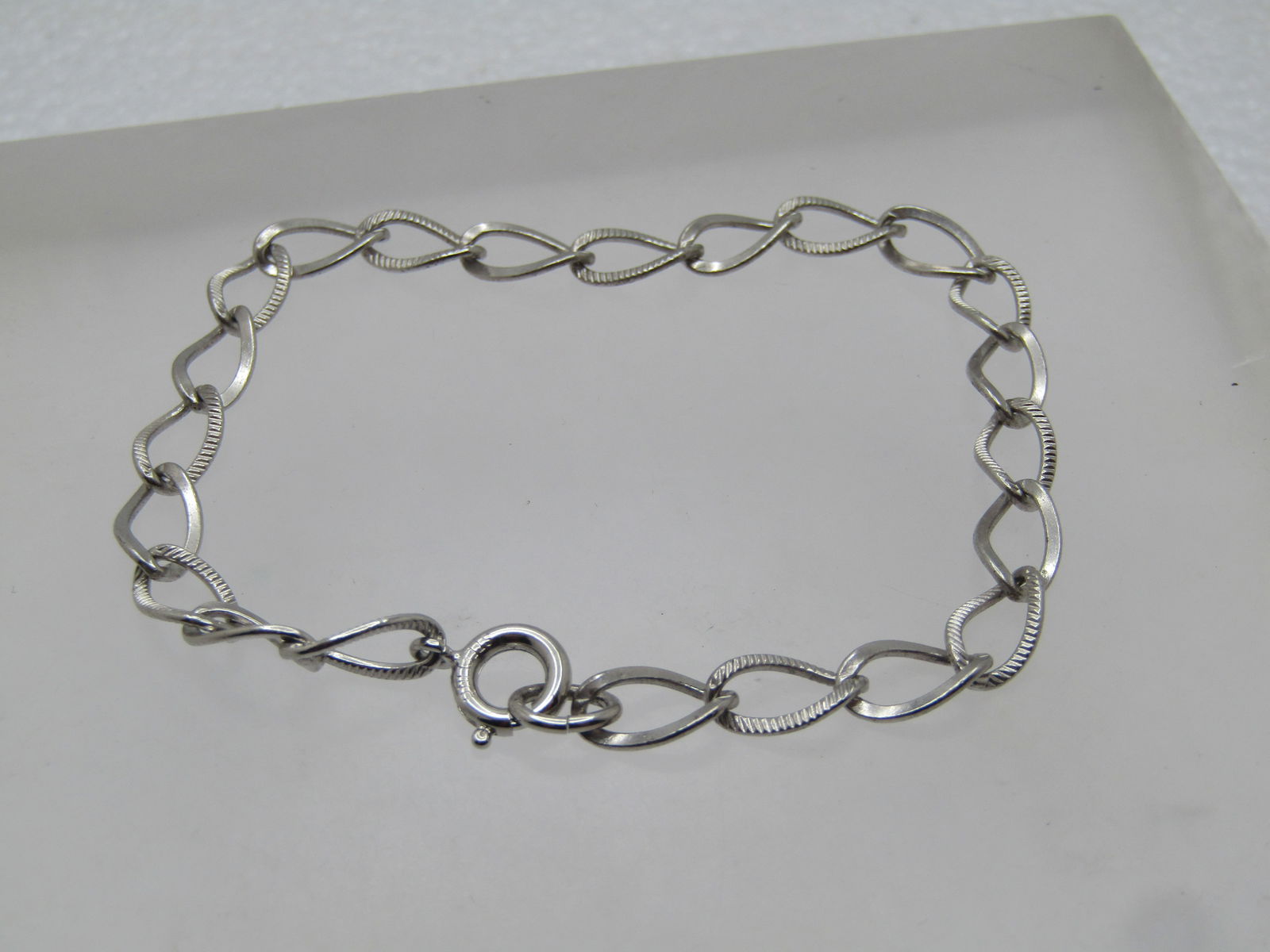 Vintage Sterling Charm Bracelet, 7", 17 Charms, 1960's-1970's: Vintage Sterling Charm Bracelet, 7", 17 Charms, 1960's-1970's. It is appx. 5.5mm wide with a spring clasp. It is marked sterling on the spring clasp and tests as sterling with a weight of appx. 3.90 g