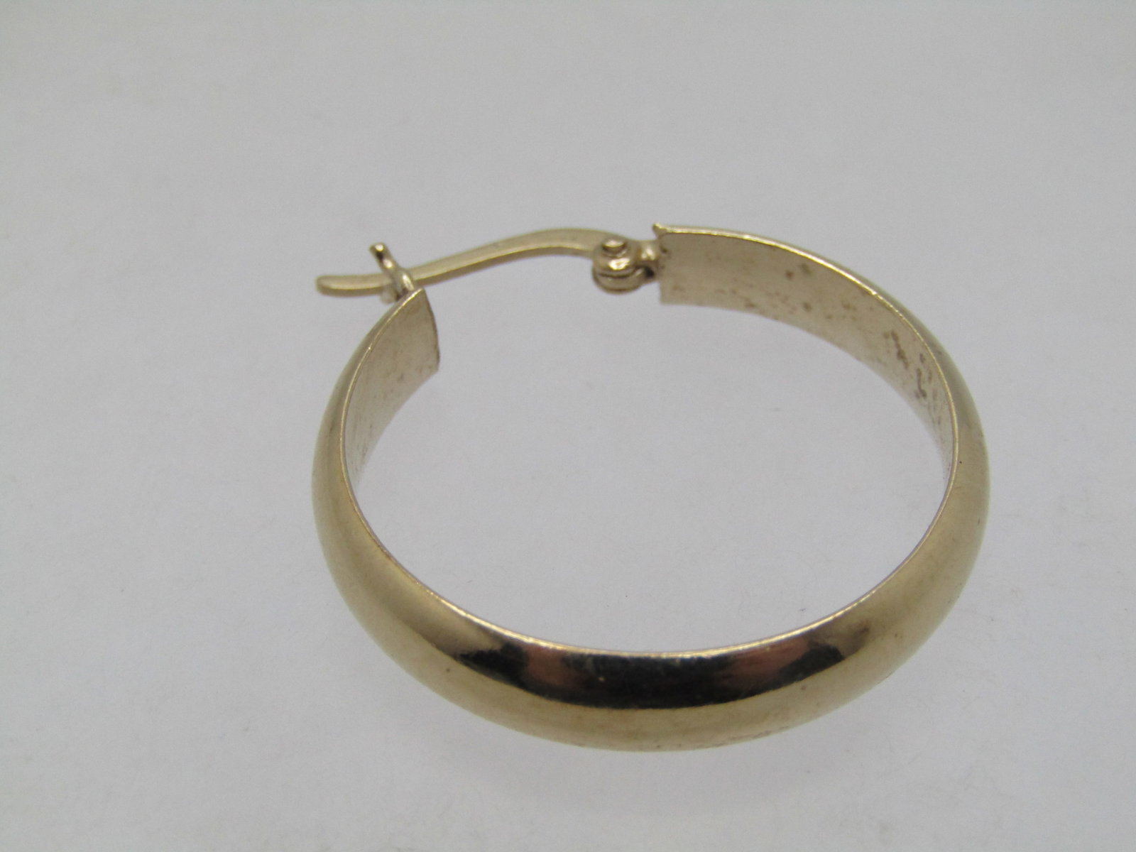 Vintage Sterling Vermeil Single Hoop Earring, Pierced, 1", 1980's-1990's.: Vintage Sterling Vermeil Single Hoop Earring, Pierced, 1" tall and appx. 5mm wide and domed. Estimated 1980's-1990's. It has a hinged locking hook post where it is marked .925 with a weight of 2.47