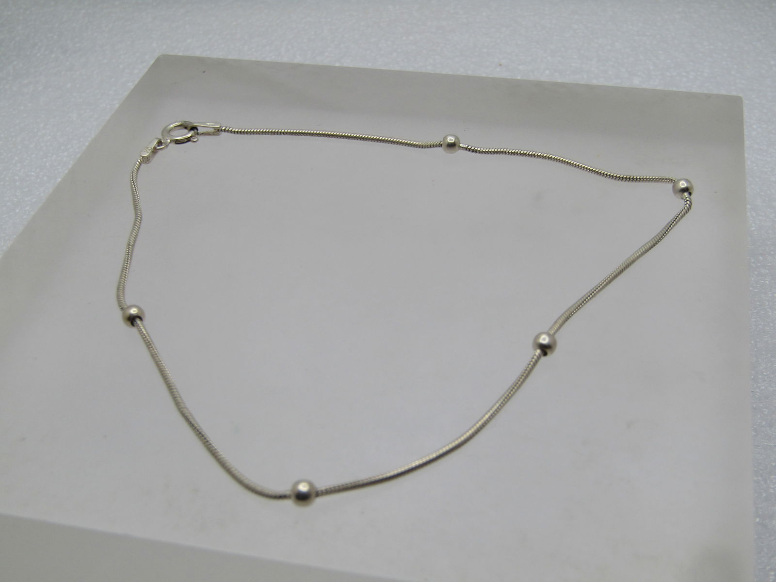 Vintage Sterling Ankle Bracelet, 10", 10" Signed KC 1980's-1990's: Vintage Sterling Ankle Bracelet, 10", 10" Signed KC 1980's-1990's. This is a rounded serpentine chain that is appx. 1mm with five 2.5mm silver beads spaced venly throughout. Spring clasp, marked